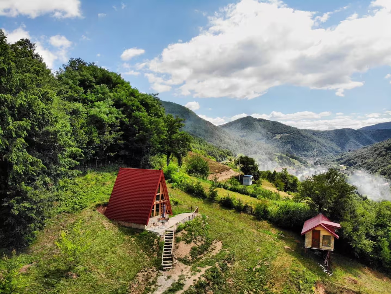 Nature Chalet aerial view — A-frame cabin on mountain slope